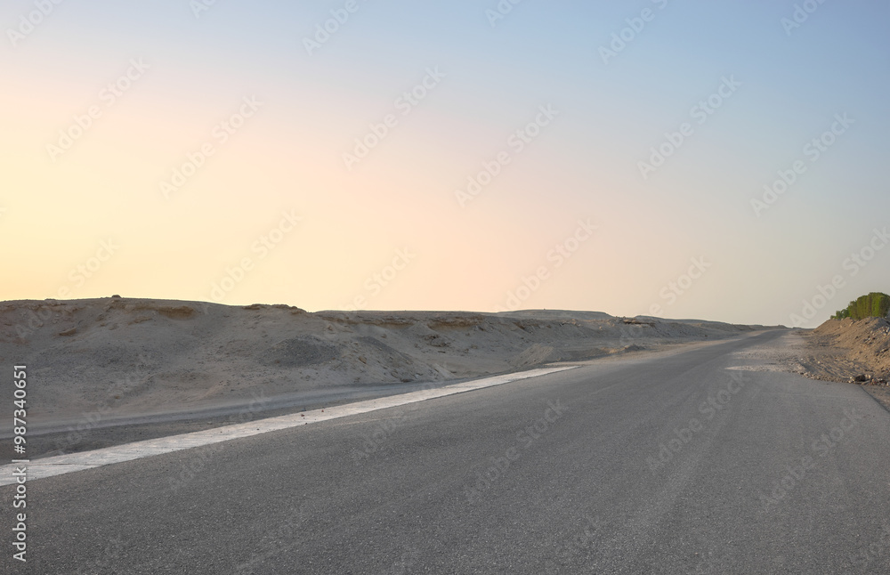 Fototapeta premium Empty desert road at sunset, front focus on asphalt, Egypt.