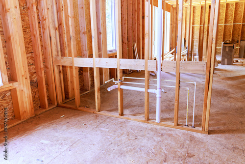 Interior of newly built house with wood studs supporting beam is unfinished