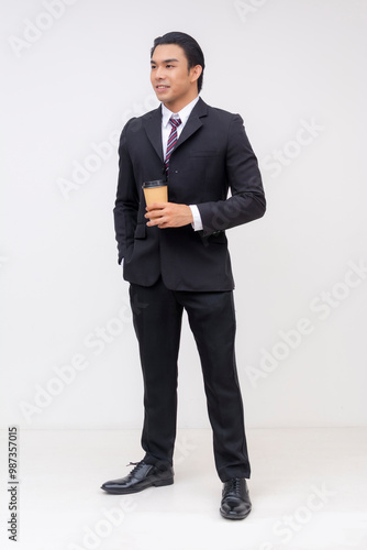 Young Asian businessman holding coffee cup on white background