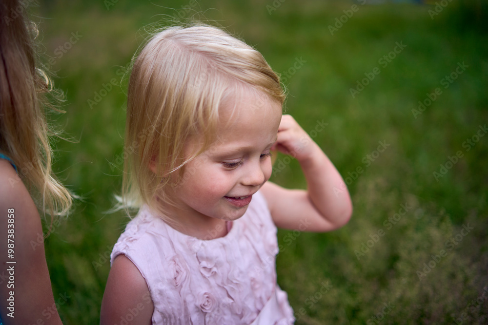 little sisters in dresses playing together in the tall grass little sisters in dresses playing together in the tall grass