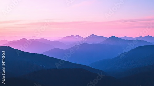 Flat lay of a mountain top view at dusk, with the sky turning shades of pink and purple as the last light of day fades behind the peaks.