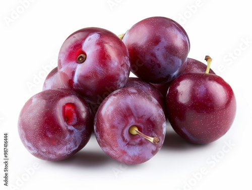 A bunch of ripe plums on a white background