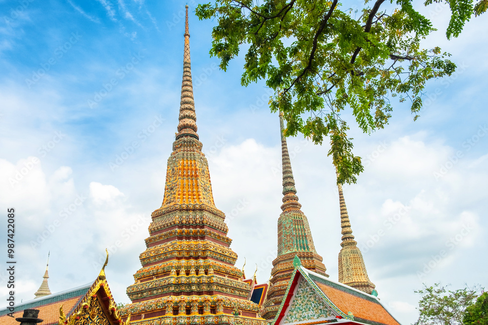 Fototapeta premium Stupas in Wat Pho Temple Complex in Bangkok city with traditional Buddhist architecture in Thailand, Asia. Temple of the Reclining Buddha. Popular tourist landmark