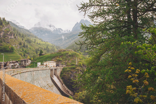 Dike at Pontechianale in Val Varaita, Italy, 2023. Wall of the dike at Pontechianale.  photo