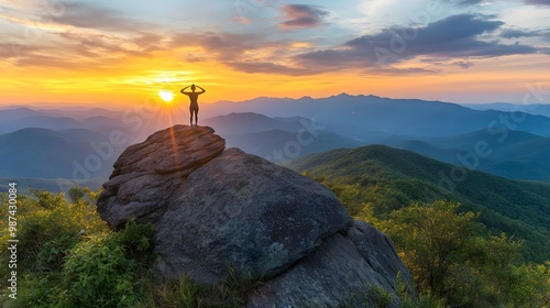 Person silhouette on rock at sunset