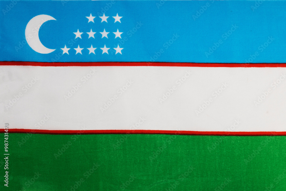 National flag of the state of Uzbekistan close-up. State background. National flag of the state of Uzbekistan close-up. State background.