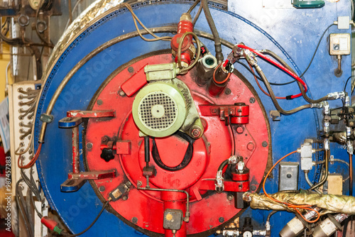 Front view of an auxiliary boiler burner with complete instrumentation. The boiler is used to produce steam for heat exchangers onboard the ship. photo