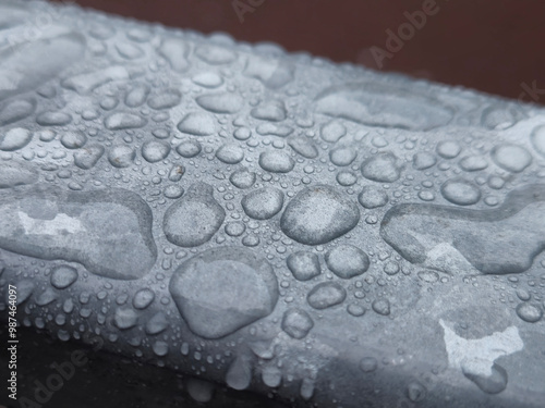 Water drops on a metal surface close view, raindrops on a fence photo