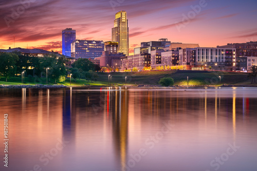 Omaha, Nebraska, USA. Cityscape image of downtown Omaha, Nebraska with reflection of the skyline at beautiful autumn sunset.