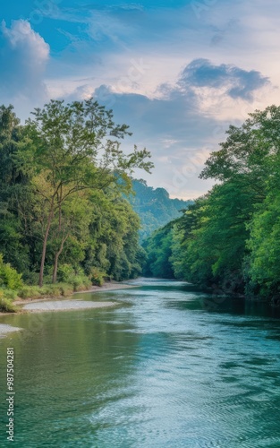 Serene River Flowing Through Lush Green Forest Under Blue Sky