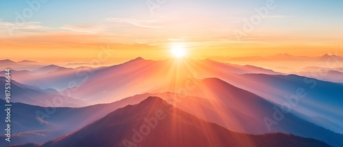 Majestic sunrise over a breathtaking mountain landscape with the sun s rays casting a warm glow across the peaks and valleys symbolizing the start of a new journey filled with hope and photo