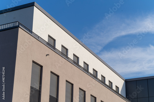 Facade of a modern building in the sun with blue sky