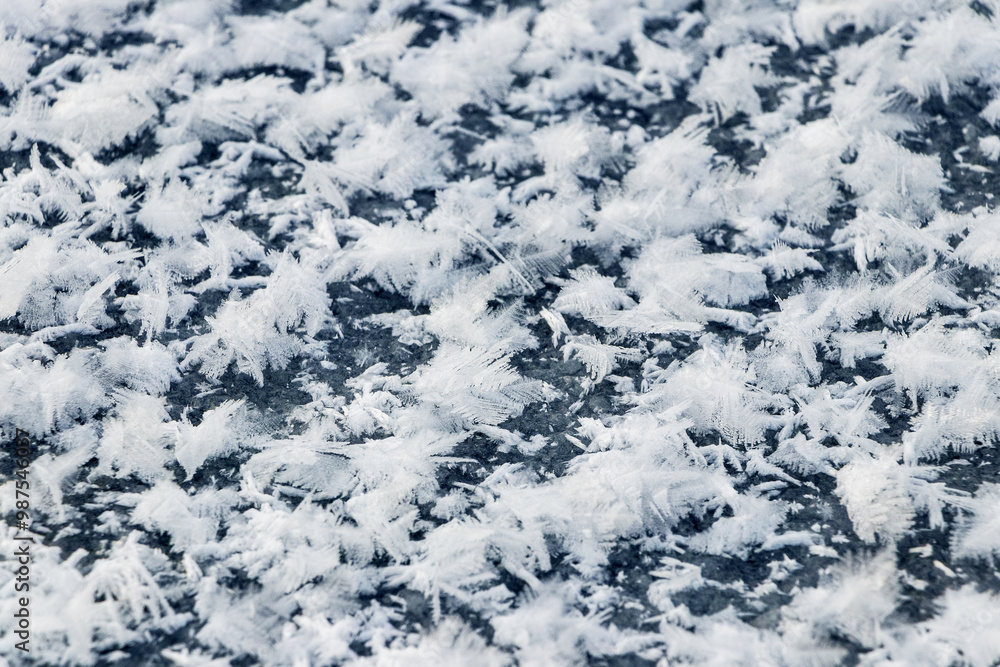 Big fluffy snowflakes on the surface of the ice. Winter and Christmas background Big fluffy snowflakes on the surface of the ice. Winter and Christmas background