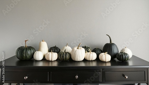 Console table decorated with black and white Halloween pumpkins and gourds