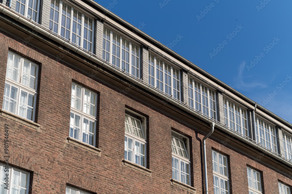 facade of an older brick building with windows facade of an older brick building with windows