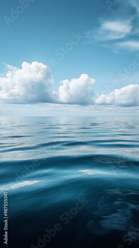 Tranquil Summer Seascape with Blue Ocean Waves and Cloudy Sky Reflection