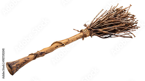 Witch’s broomstick with twisted wooden handle and straw bristles, isolated on a white background photo