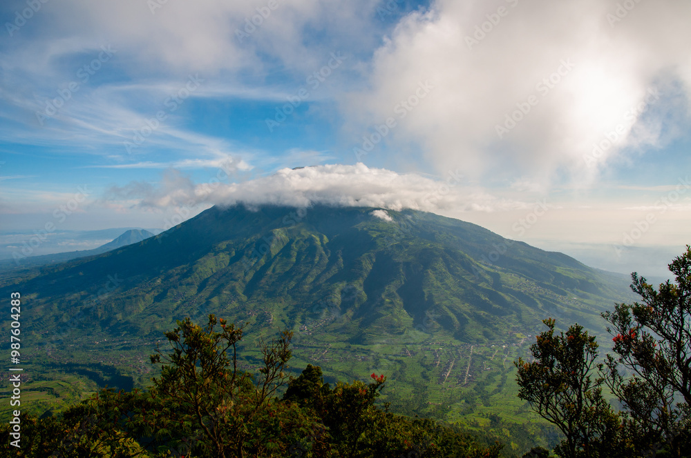 Panoramic view of the Mount Merbabu National Park with circle of clouds on the top Panoramic view of the Mount Merbabu National Park with circle of clouds on the top