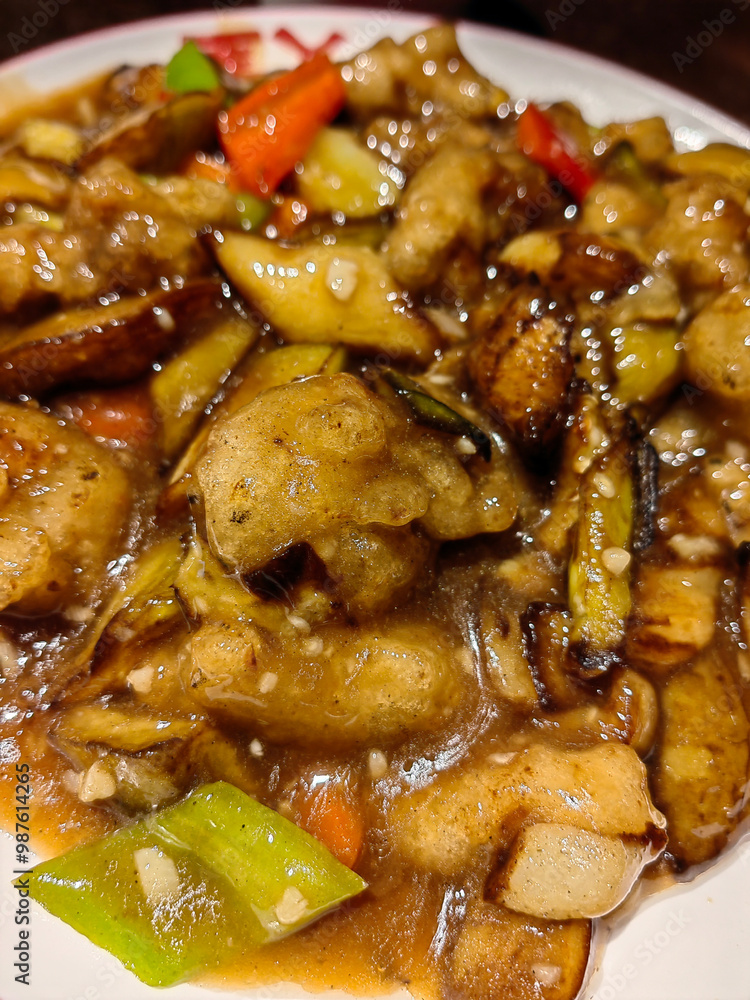 Chinese cuisine eggplant to share with people eating with chopsticks and plates bowls Chinese cuisine eggplant to share with people eating with chopsticks and plates bowls