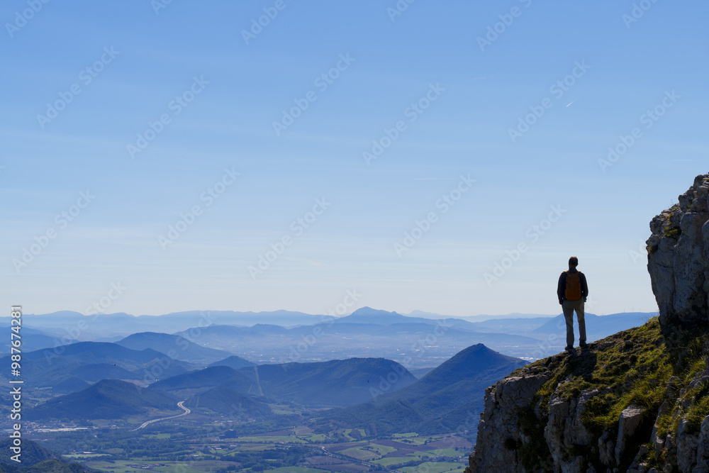 Hiker looking at the landscape. Sakana Valley from the Aralar mountain range, Navarra. Hiker looking at the landscape. Sakana Valley from the Aralar mountain range, Navarra.