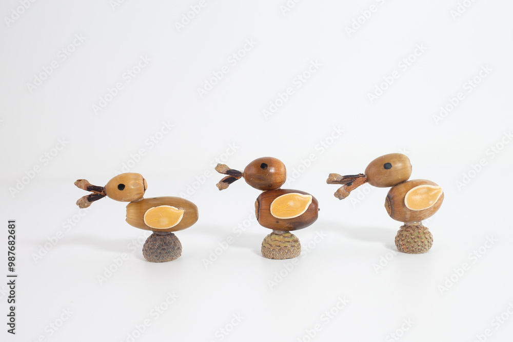 Row of ducks made of acorns with natural details. Creative autumn Craft, Perfect for fall themed decor, Row of ducks made of acorns with natural details. Creative autumn Craft, Perfect for fall themed decor,