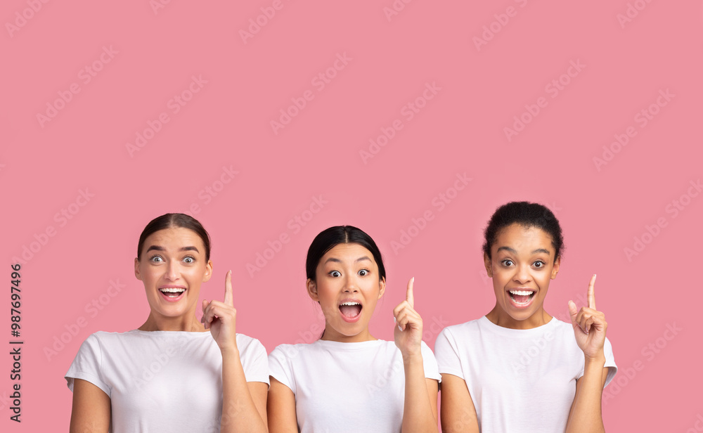 Idea. Three Millennial Girls Pointing Finger Up Having Eureka Moment Standing Over Pink Studio Background. Panorama Idea. Three Millennial Girls Pointing Finger Up Having Eureka Moment Standing Over Pink Studio Background. Panorama