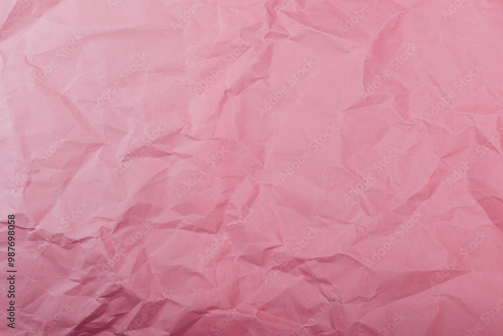 Texture of crumpled pink eco-paper. The concept of using natural materials for packaging. Texture of crumpled pink eco-paper. The concept of using natural materials for packaging.