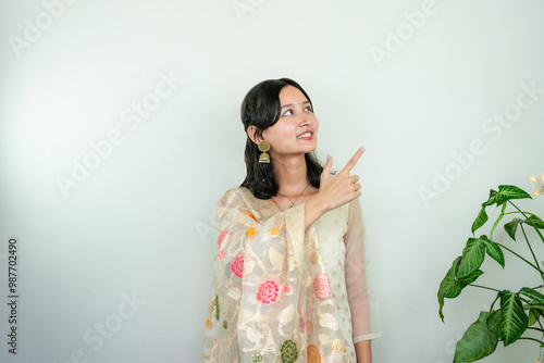 Beautiful Asian Female in Kurtha for Diwali giving Expressions & Gestures with LED Christmas Lights photo