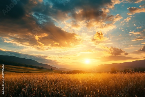 Golden sunset over vast field with mountains in the background