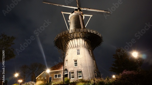 Molen De Valk windmill at night with a dark sky background on the Leiden city walls in Netherlands photo