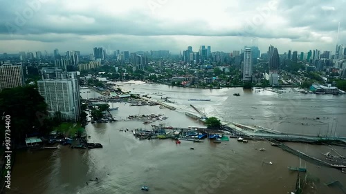 Drone footage of a flooded river caused a damage in a city under cloudy sky