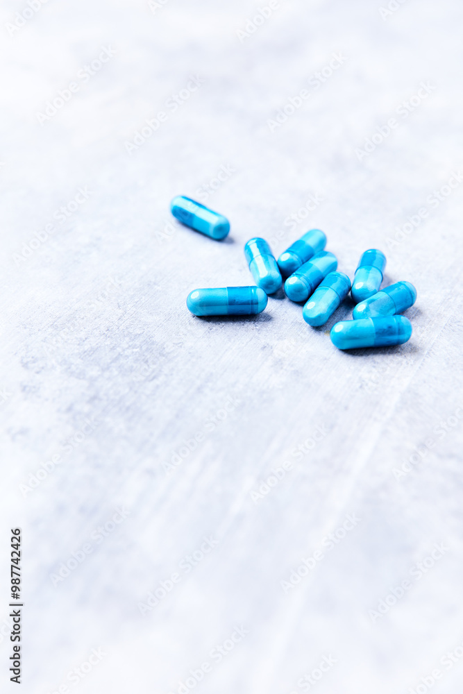 Amino acids capsules on bright stone background. Soft focus. Close up. Copy space. Amino acids capsules on bright stone background. Soft focus. Close up. Copy space.