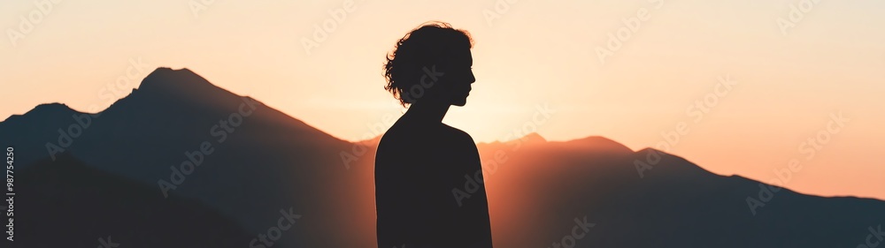 Silhouette of a person against a breathtaking sunset backdrop, showcasing tranquility and the beauty of nature's colors. Silhouette of a person against a breathtaking sunset backdrop, showcasing tranquility and the beauty of nature's colors.