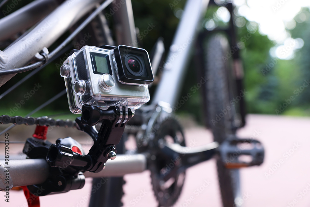 Modern action camera with mount on bicycle outdoors, closeup Modern action camera with mount on bicycle outdoors, closeup
