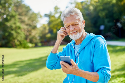 man outdoor senior elderly phone fitness mobile smartphone music earphone app communication active fun old nature using internet connection smart phone mature retirement listen headphone training