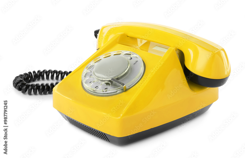 Old yellow telephone with rotary dial isolated on white