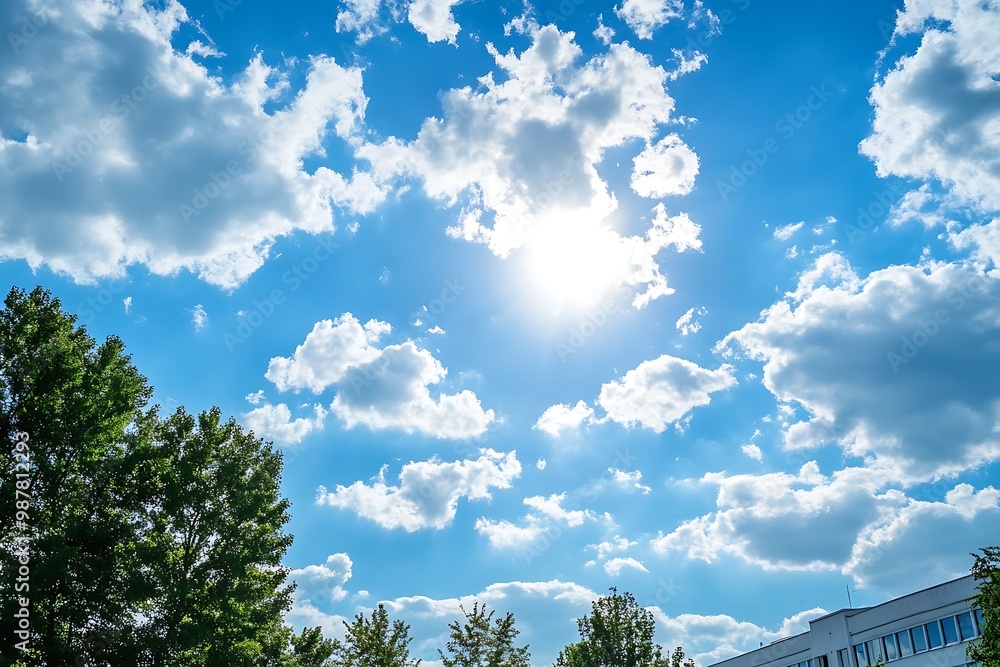 Obraz premium Sunny day with white fluffy clouds in blue sky