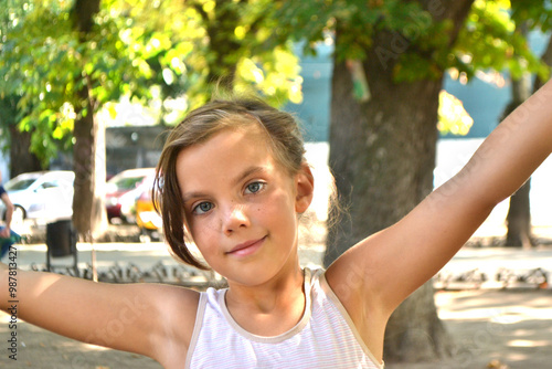 Cute kid girl 10 year old posing on nature background. Looking at camera. Childhood.Blonde girl emotions. High quality photo photo