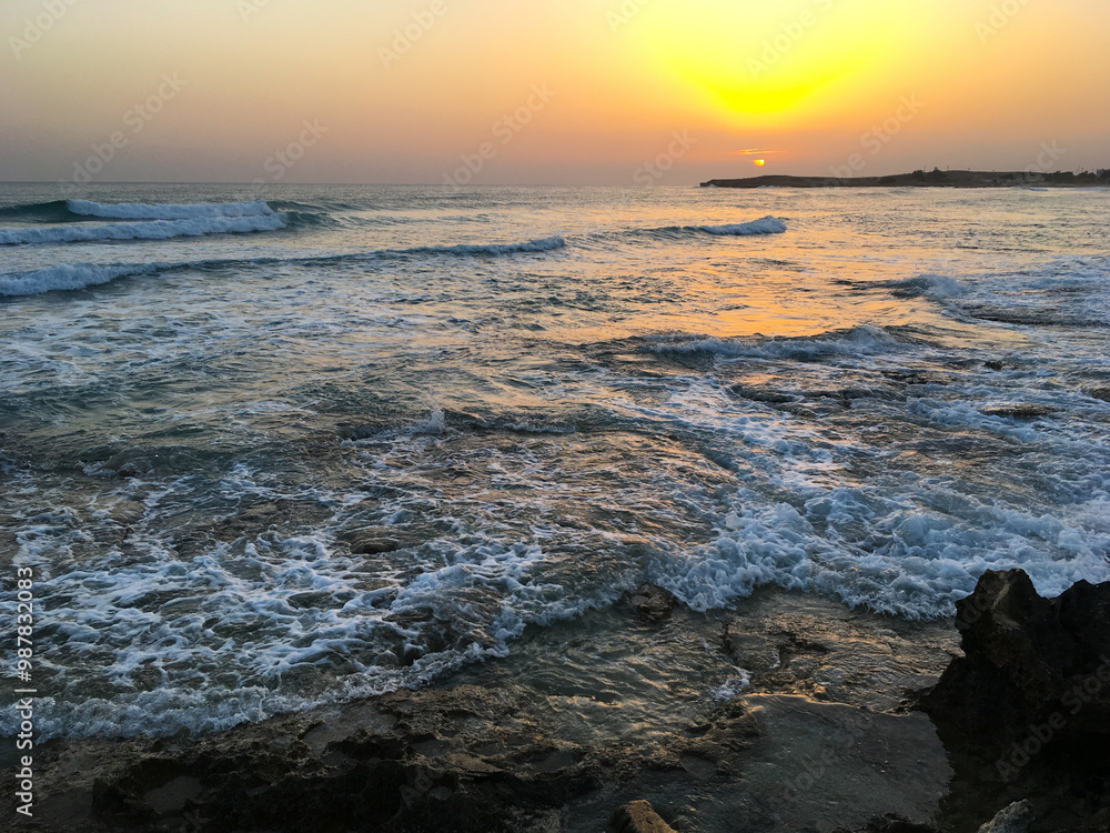 Naklejka premium Sunset in Cyprus. View of coast at sunset. Promenade of the Mediterranean sea. Evening landscape of Cyprus.