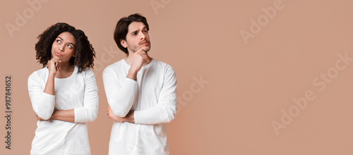 Solution Thinking. Portrait of pensive interracial couple with thoughtful face expression over yellow studio background with empty space photo