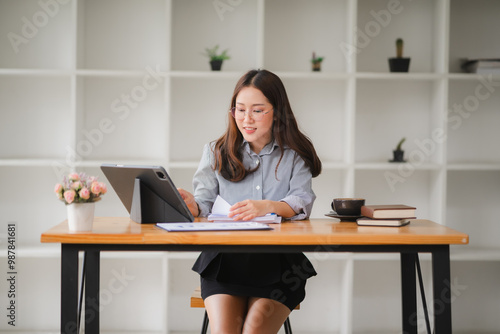 Focused Female Professional Navigates Digital Documents at a Modern Workspace 