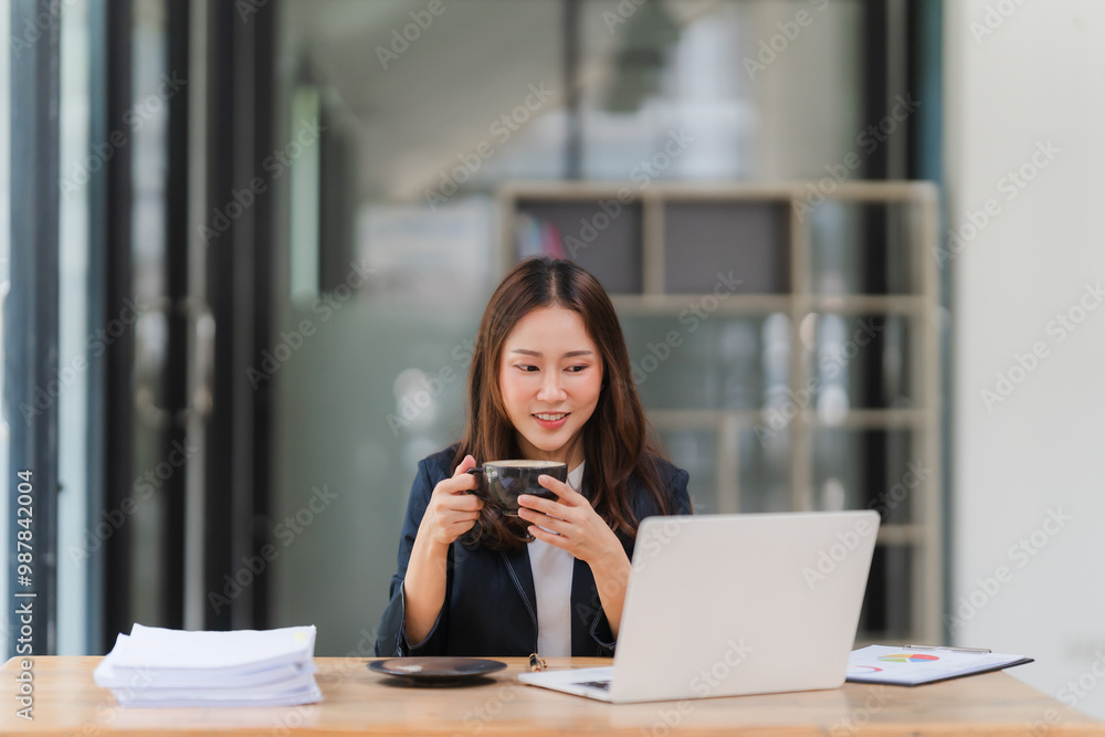 Focused Asian Businesswoman Enjoys Coffee Break Focused Asian Businesswoman Enjoys Coffee Break
