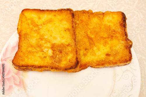 Golden brown french toast on a flower plate