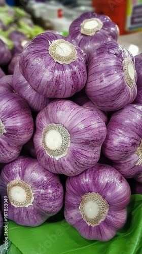 Fresh purple garlic bulbs stacked for sale at a local market in the afternoon...