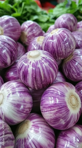 Fresh purple garlic bulbs stacked for sale at a local market in the afternoon...