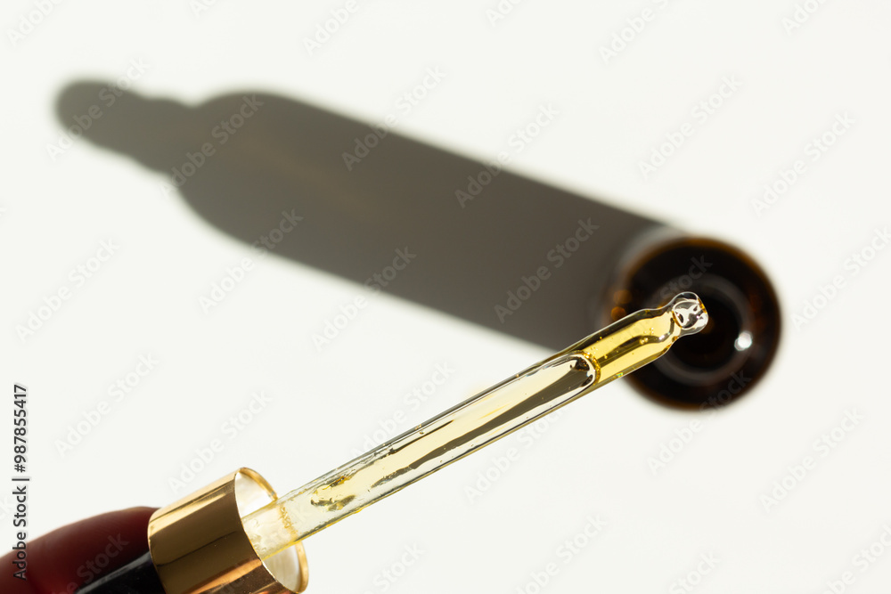 Closeup of a pipette with organic rosehip facial oil. 