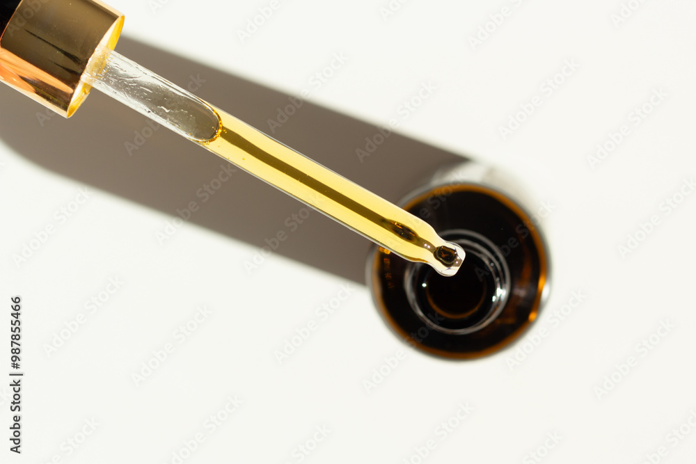 Closeup of a pipette with organic rosehip facial oil.