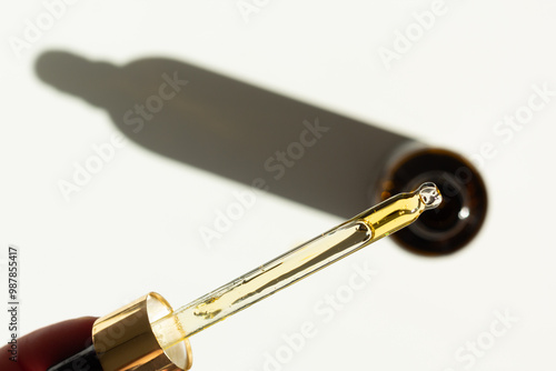 Obraz na płótnie Closeup of a pipette with organic rosehip facial oil. w salonie