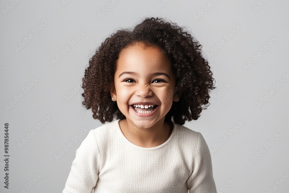 Delightful Studio Portrait of a Joyful Mixed Race Girl Smiling Brightly with Gleaming Teeth on a Crisp White Background Delightful Studio Portrait of a Joyful Mixed Race Girl Smiling Brightly with Gleaming Teeth on a Crisp White Background