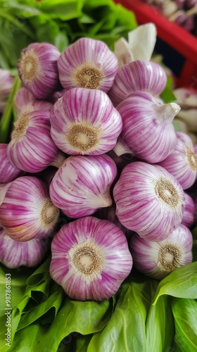 Fresh purple garlic bulbs stacked for sale at a local market in the afternoon...